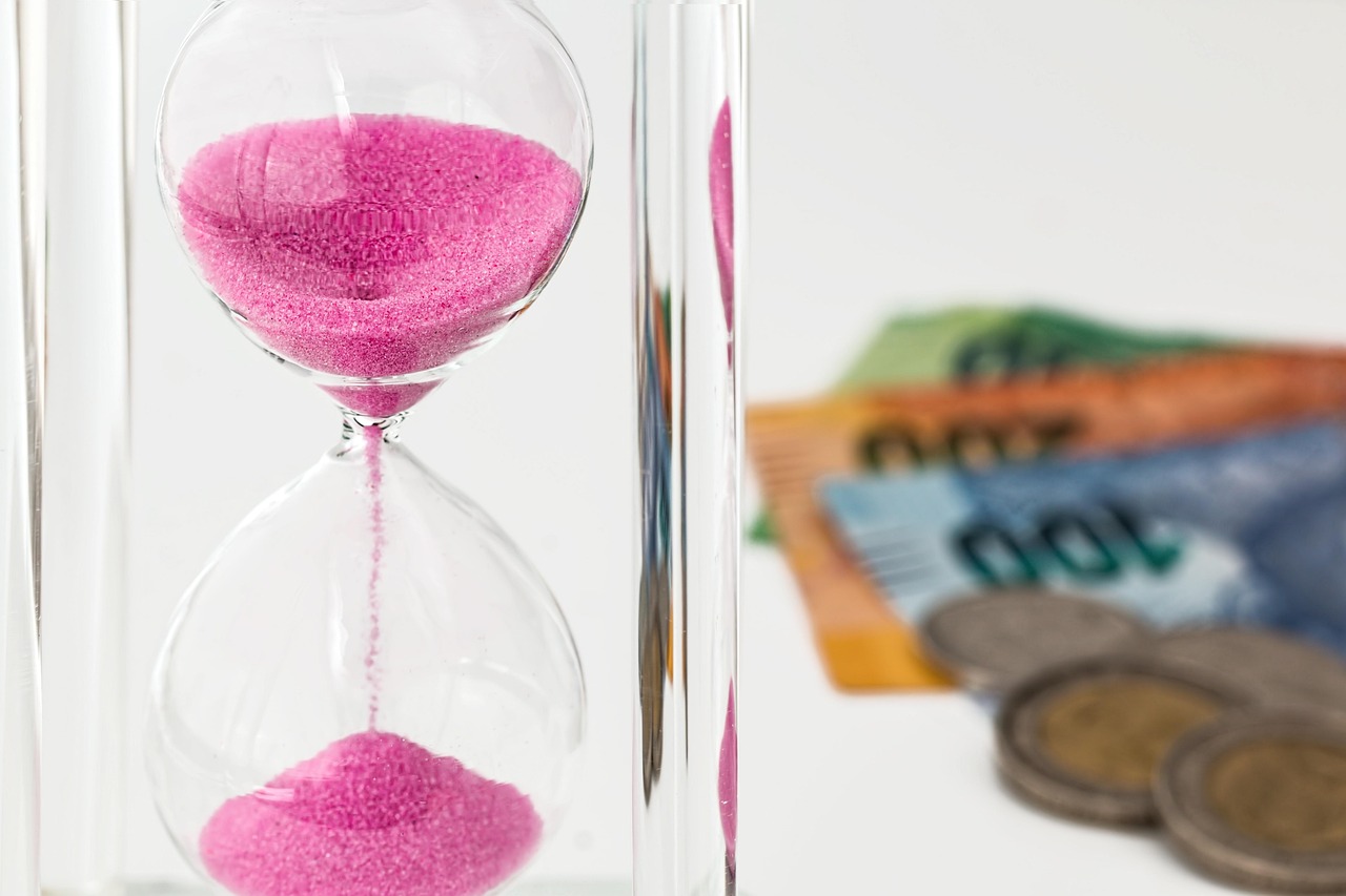 Hourglass, money, time — How to Drastically Reduce Your Family Debts and Expenses