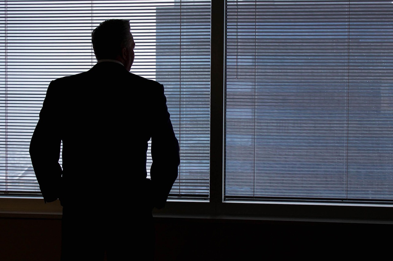 Businessman, silhouette, windows — How to Prepare for Moving Your Items During Winter