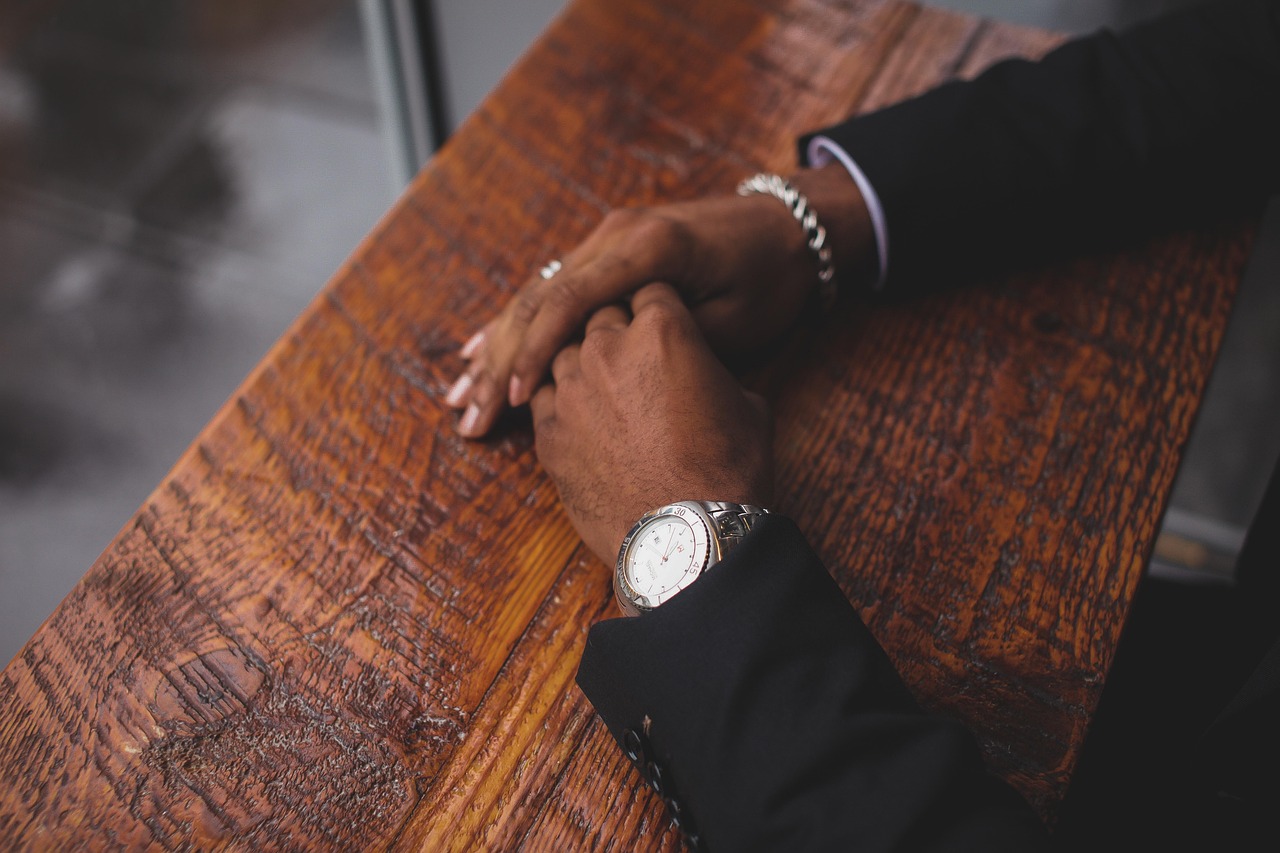Business, hands, wristwatch — Types of life insurance plans and their benefits