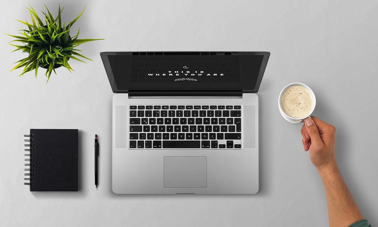 Laptop, coffee, arm — Typical Information In The World Of Company Secretary Service